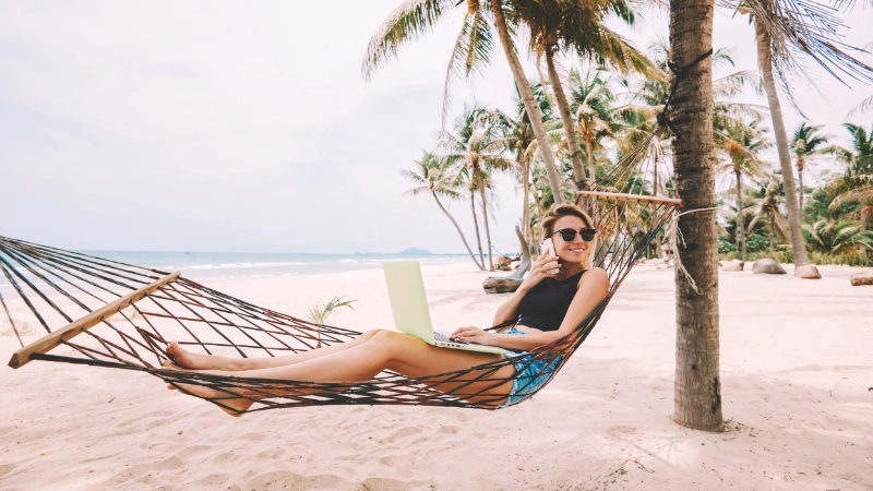 Traveller using laptop at the beach